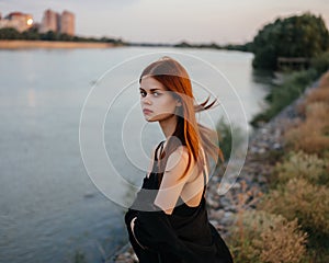 Red-haired woman black veil nature posing