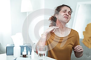 Red-haired woman having reddening and rash on her neck