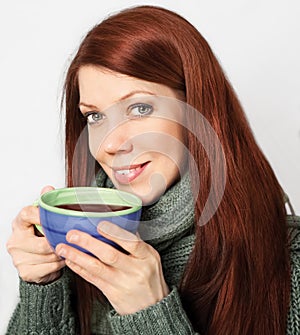 Red-haired woman holding cup