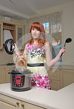 Red haired woman with new multicooker and small dog