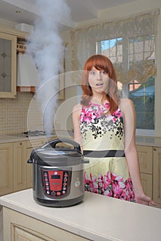 Red haired woman with new multicooker