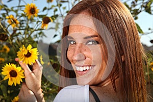 Red Haired Woman Outdoors in a Sunflower Field