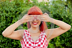 Red haired woman covering her eyes