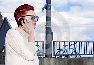 Red-haired woman talking on the phone