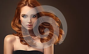 Red haired woman with voluminous, shiny and curly hairstyle.Flying hair.