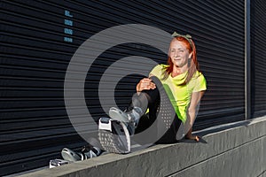 Red-haired woman wearing sportswear and Kangoo Jumps boots