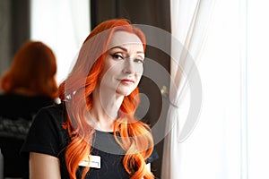 Red-haired woman working out in a beauty salon