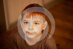 Red-haired young boy in thought, attention