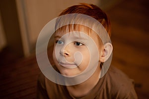 Red-haired young boy in thought, attention
