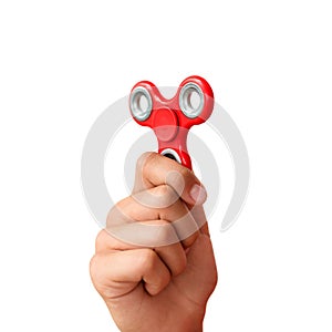 Red hand spinner. Boy playing a popular toy fidget spinner in his hand. Stress relief. Anti stress and relaxation adhd attention f