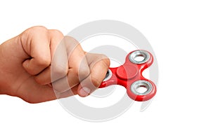 Red hand spinner. Boy playing a popular toy fidget spinner in his hand. Stress relief. Anti stress and relaxation adhd attention f
