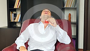 Red hand spinner, or fidgeting spinner, rotating on man`s hand. Man in a suit spinning a fidget spinner in his office at