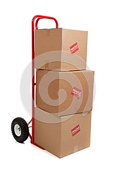 A red hand truck on white with boxes