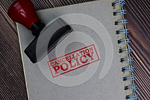 Red Handle Rubber Stamper and Cancellation Policy text isolated on the table