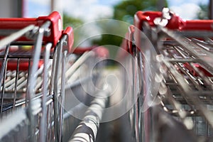 Red handles of shopping carts in 2 rows. photo