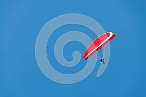 Red Hang Glider in a Deep Blue Sky