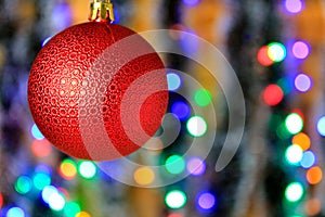 Red hanging ball, christmas decoration with blurred lights background.