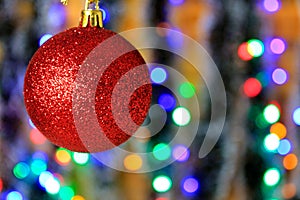 Red hanging ball, christmas decoration with blurred lights background.