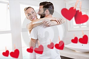 Red hanging heart and couple embracing each other