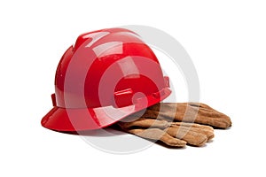 Red hard hat and leather work gloves on white