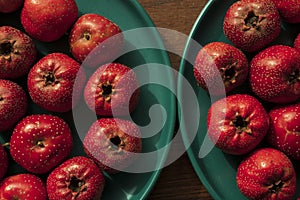 red hawthorns on wood table