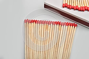 Red head matches in a white opened box on white background