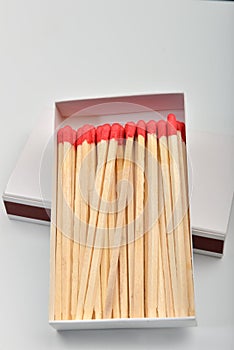 Red head matches in a white opened box on white background