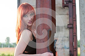 Red head streaptease girl urban concrete destruct landscape