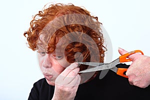 Red head woman cutting hair