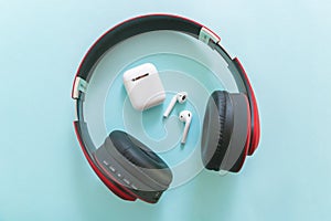 Red headphone and earphone on a blue  background photo