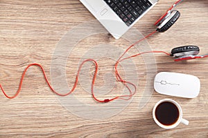 Red headphones, coffee, computer keyboard and mouse