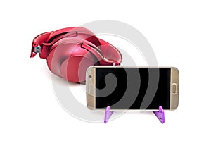Red headphones and mobile phone on tripod,isolated on white background