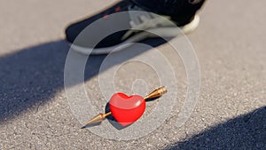 Red heart with amor arrow on the asphalt, bokeh