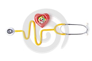 Red heart, asorted pils and a stethoscope on white background.