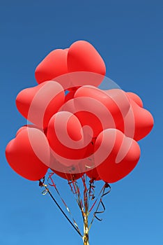 Red heart balloons flying in the skies