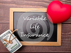 Red heart and banknotes with the word Variable Life Insurance