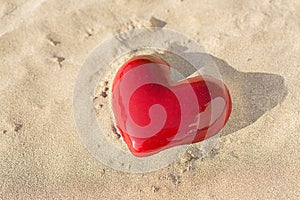 Red heart on the beach