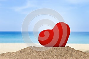 Red heart on the beach, love and romance concept