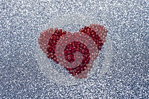 Round glitter red sequin in heart shape isolated on white background - love and valentine concept photo