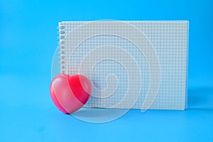 Red heart and booknote on background