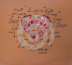 Red heart on a brown background with written words of love