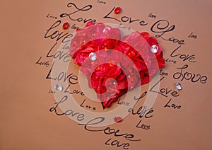 Red heart on a brown background with written words of love