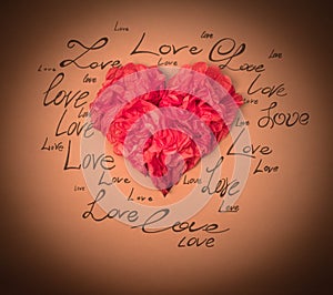 Red heart on a brown background with written words of love