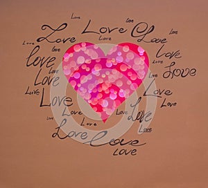 Red heart on a brown background with written words of love