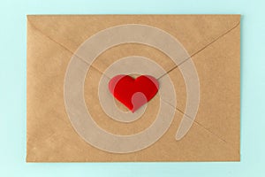 Red heart on brown envelope. Love letter for valentine`s day.