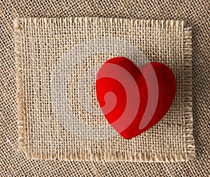 Red heart on burlap, sackcloth background. Valentines Day