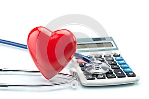 Red heart and calculator with stethoscope on white background