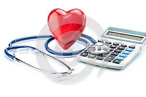 Red heart and calculator with stethoscope on white background