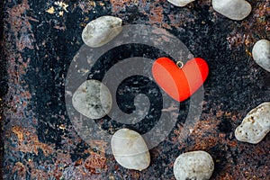 Red heart in circle of rocks