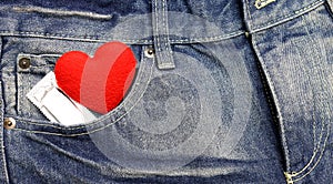 Red heart and condom with blue jean